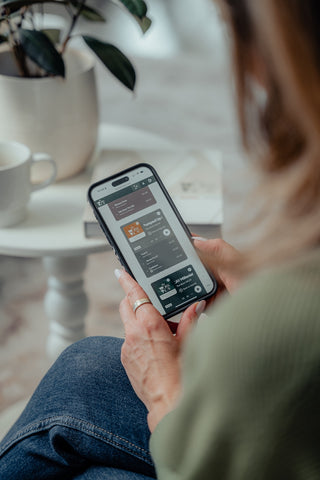 Woman looking at her mobile device scrolling through playlists.
